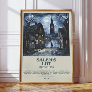 May include: Framed poster of Stephen King's "Salem's Lot" with a dark, atmospheric illustration of a town at night. The artwork depicts a full moon, a church steeple, and shadowy figures. The poster includes the title, author, and a brief synopsis.