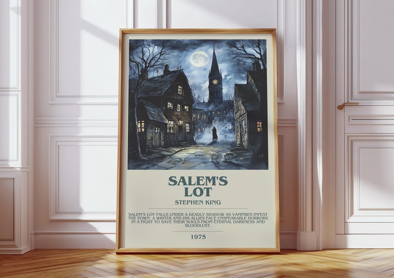 May include: Framed poster of Stephen King's "Salem's Lot" with a dark, atmospheric illustration of a town at night. The artwork depicts a full moon, a church steeple, and shadowy figures. The poster includes the title, author, and a brief synopsis.