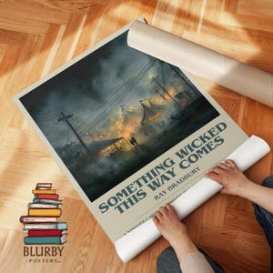 May include: A rolled poster with the title "SOMETHING WICKED THIS WAY COMES" by Ray Bradbury. The poster features a dark, atmospheric illustration of a carnival scene with tents and figures. A stack of colorful books and the "BLURBY - POSTERS -" logo are visible.