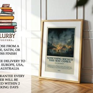 May include: Framed poster featuring the title "Something Wicked This Way Comes" by Ray Bradbury. The artwork depicts a nighttime carnival scene with tents and power lines. The poster is in a wooden frame.