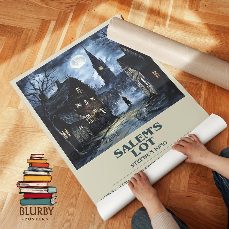 May include: A rolled poster featuring a dark, atmospheric illustration of a town at night, with the title "Salem's Lot" by Stephen King. The image shows a spooky street scene with a full moon and a tall church steeple.