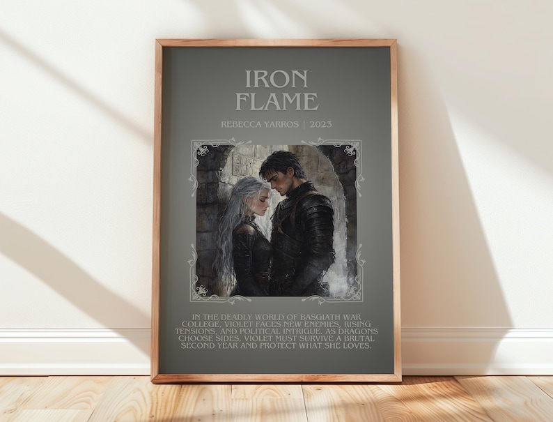 May include: Framed poster with the title "Iron Flame" and author Rebecca Yarros, 2023. The artwork features a couple in dark attire, set against a gray background. Text below describes the story's plot involving war, dragons, and survival.