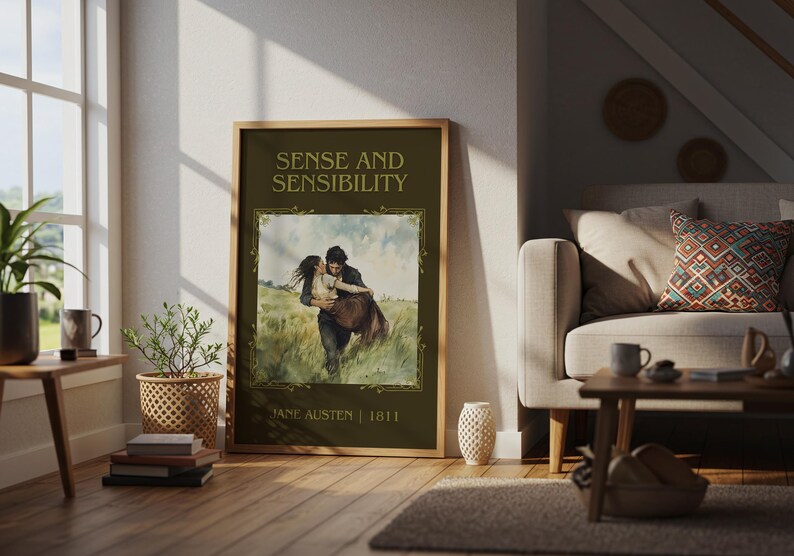 May include: A framed poster of "Sense and Sensibility" by Jane Austen, featuring a romantic watercolor illustration of a couple embracing in a field. The poster has a dark green background with gold lettering and a wooden frame, displayed in a living room.