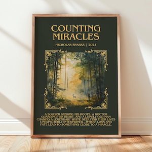 May include: A framed poster with the title "COUNTING MIRACLES" by Nicholas Sparks, 2024. The poster features a forest scene with a deer and a person. The text below describes the story's plot.