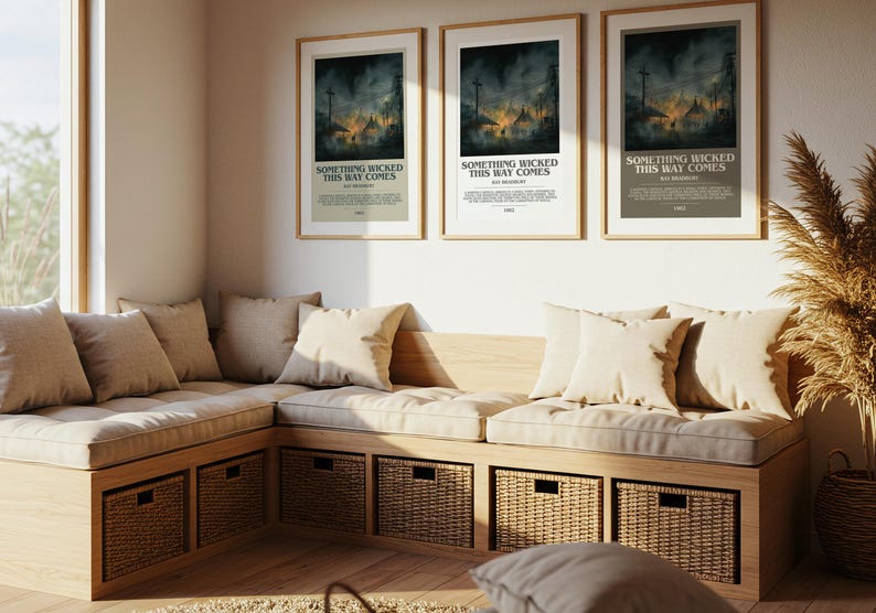 May include: Three framed posters with the text "SOMETHING WICKED THIS WAY COMES" hang above a built-in bench with beige cushions and pillows. The bench has woven storage baskets underneath. A large window and decorative plant are also visible.