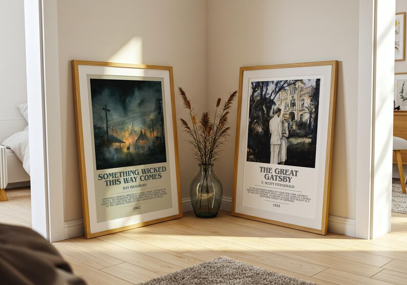 May include: Two framed movie posters, leaning against a wall. One features the text "SOMETHING WICKED THIS WAY COMES" and the other "THE GREAT GATSBY". Both posters are in wooden frames and have a cream-colored border.