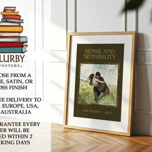May include: A framed poster of "Sense and Sensibility" by Jane Austen. The artwork depicts a couple embracing, set against a field. The poster is in a wooden frame and is displayed on a wooden floor. The poster includes the text "BLURBY -POSTERS-".