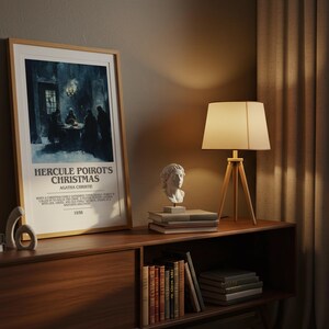 May include: A framed poster for "Hercule Poirot's Christmas" by Agatha Christie, displayed on a wooden cabinet. The scene includes a lamp, bust sculptures, and books. The poster is in a light wood frame.