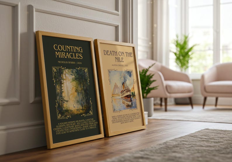 May include: Two framed book covers, "Counting Miracles" and "Death on the Nile," lean against a wall. The "Counting Miracles" cover is dark green with gold accents and forest imagery. "Death on the Nile" features a ship illustration. Both are in wooden frames.