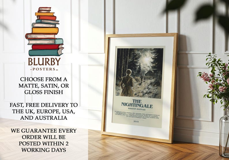 May include: A framed poster of "The Nightingale" by Kristin Hannah, featuring a woman walking in a forest. The poster is in a light wood frame, leaning against a white wall. The poster is on a wooden floor.