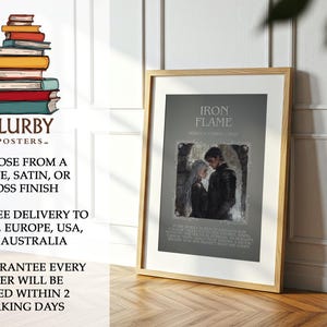 May include: A framed poster with the text "IRON FLAME" and an image of a couple. The poster is in a wooden frame and is displayed on a wooden floor. The poster is from "BLURBY - POSTERS-".