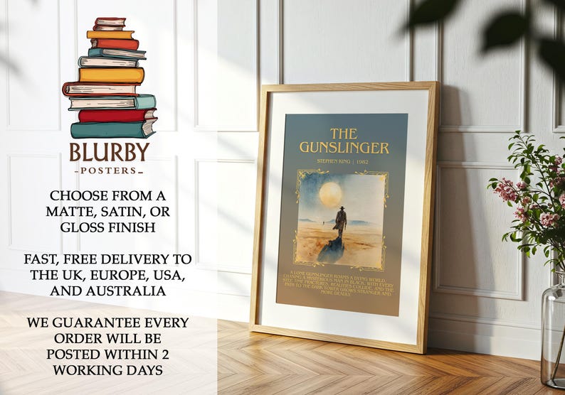 May include: A framed poster of "The Gunslinger" book cover art by Stephen King. The image shows a figure on a beach under a large moon. The poster is in a wooden frame and is leaning against a wall. The poster is part of a series.