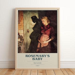May include: Framed poster of the movie "Rosemary's Baby" by Ira Levin, 1967. The artwork depicts a woman in a red shirt and apron, holding her pregnant belly. A shadow of a man is behind her.