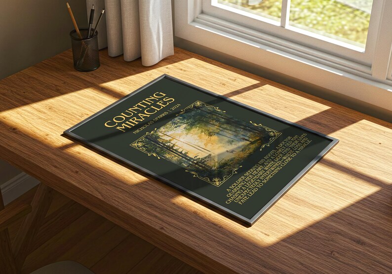 May include: A framed art print titled "Counting Miracles" by Nicholas Sparks. The print features a dark green background with gold lettering and a landscape image. The frame is silver.