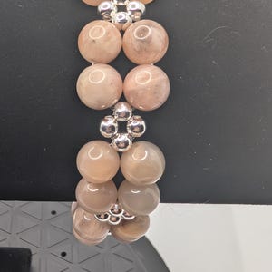 Handmade beautiful Art Deco style natural peach moonstone beaded bracelet with silver bead highlights in a unique cross and square design