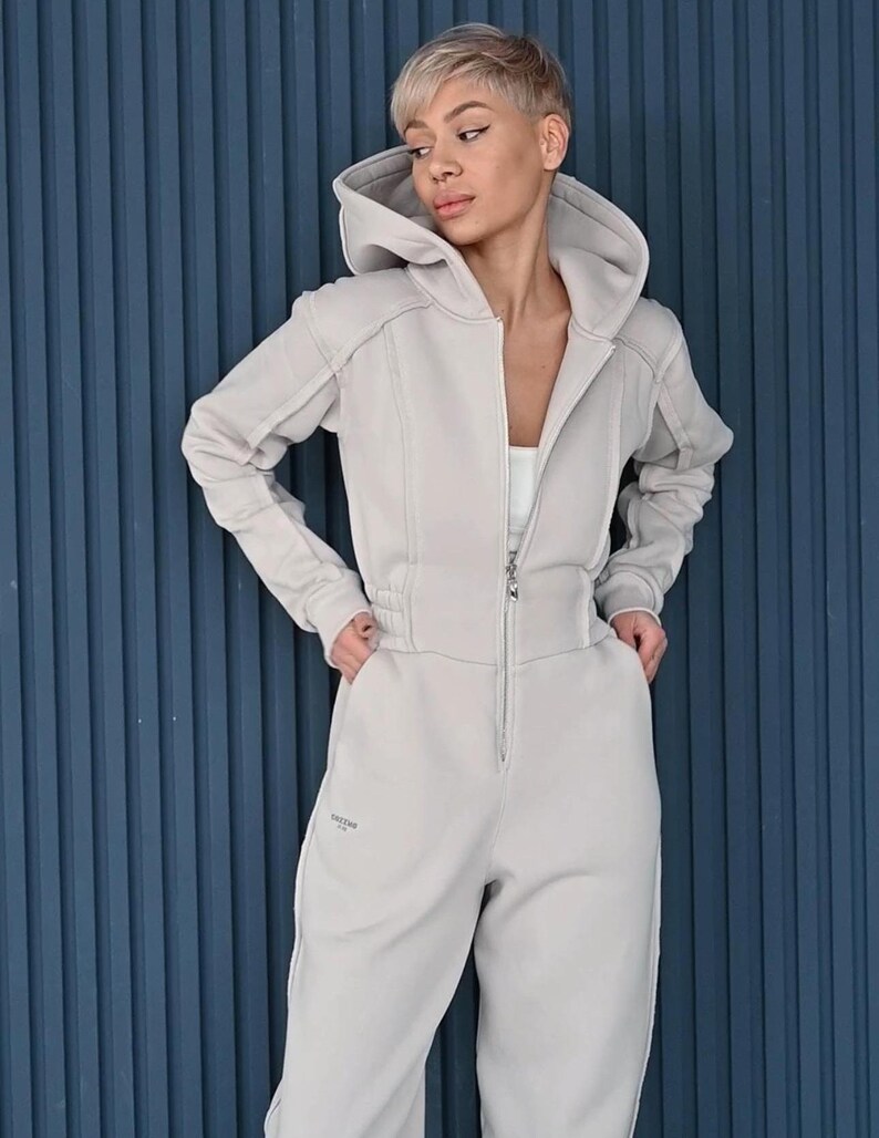 Beige cotton jersey women's jumpsuit, comfortable casual one piece with hood, zipper front overall, relaxed fit lightweight loungewear with pockets
