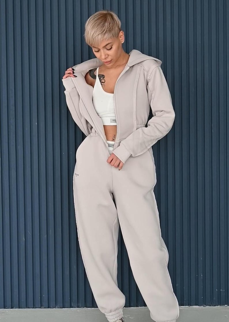 Lightweight beige jumpsuit styled with white top, women's cotton jersey overall with zipper, casual one piece loungewear, comfortable everyday romper