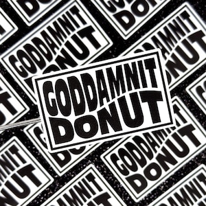 May include: A close-up of multiple black and white stickers with the text "GODDAMN IT DONUT" repeated on each sticker.