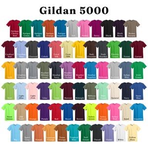 May include: A collection of Gildan 5000 t-shirts in various colors, including red, blue, green, and black. The image displays a wide array of hues, with each shirt labeled with its specific color name. The text "Gildan 5000" is at the top.