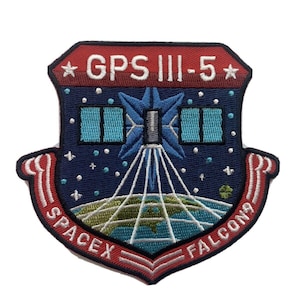 May include: Embroidered patch with a shield design. The patch features the text "GPS III-5" in red, along with "SPACEX FALCON9". The design includes a satellite, Earth, and stars, with blue, white, and green colors.