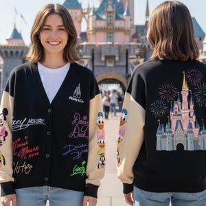 Puede incluir: Cárdigan negro con mangas beige con personajes y firmas de Disney. La parte delantera muestra a Mickey Mouse, Minnie Mouse y otros personajes. La parte trasera muestra un castillo con fuegos artificiales. "Mickey & Co." está impreso en la parte delantera.