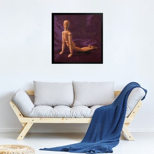 May include: A wooden artist's mannequin posed in a kneeling position on a purple fabric background. The mannequin is made of wood and has a natural finish.