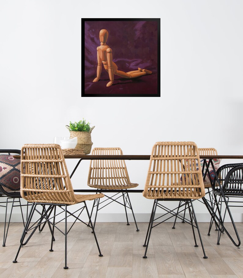 May include: A wooden artist's mannequin posed in a kneeling position on a purple background. The mannequin is made of wood and has a natural finish. The background is a deep purple color.