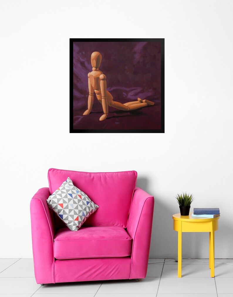 May include: A wooden artist's mannequin posed in a kneeling position on a purple fabric background. The mannequin is made of wood and has a natural finish.