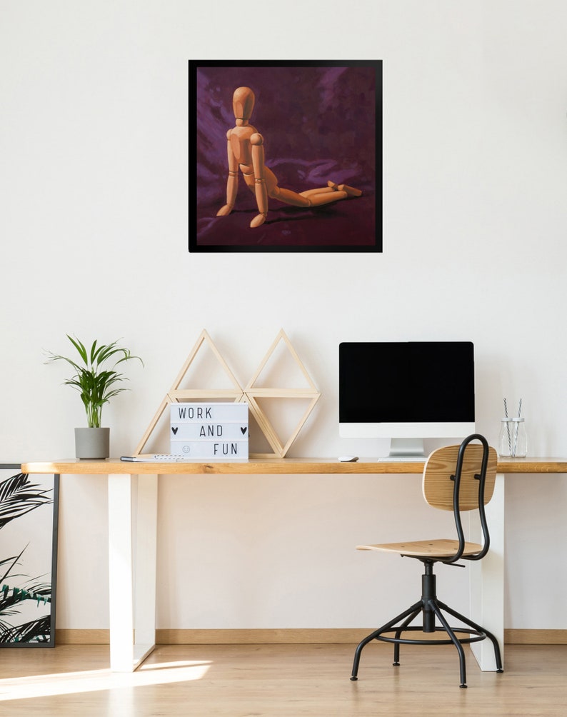 May include: A wooden artist's mannequin posed in a kneeling position on a purple fabric background. The mannequin is made of wood and has a natural finish. The background is a deep purple color and has a soft, velvety texture.