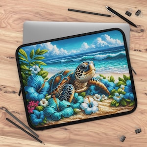 May include: Laptop sleeve featuring a sea turtle on a sandy beach with blue hibiscus flowers and ocean waves under a blue sky. The turtle has a brown and blue shell and is surrounded by vibrant blue flowers.