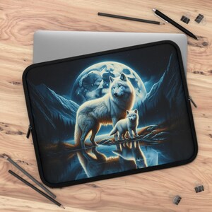 May include: Black laptop sleeve featuring a digital art print of two white wolves standing near a body of water, with a full moon in the background. The wolves are reflected in the water, with mountains and trees in the distance. The sleeve has a black zipper.