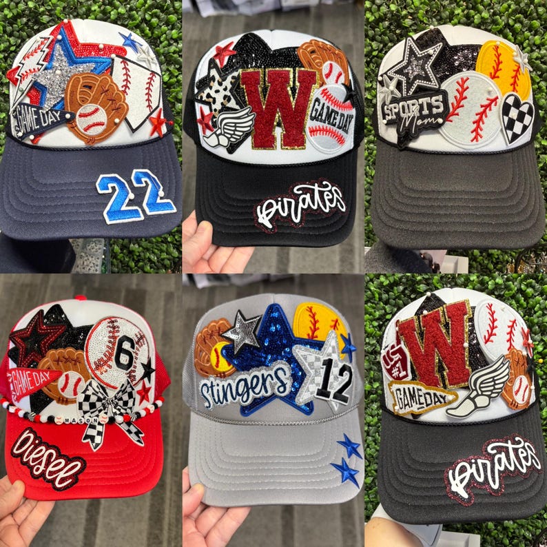 May include: A selection of baseball-themed trucker caps. Each cap has a unique design with baseballs, stars, and text such as "Game Day" and "Pirates." Colours include red, white, blue, and black. Numbers and team names are also displayed on the caps.