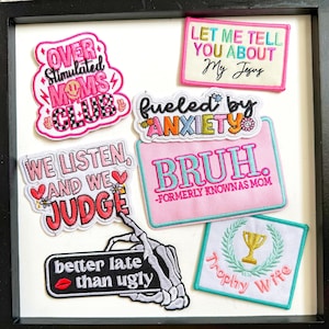 May include: A white ceramic mug with a black handle and the text "But First, Coffee" in a black, bold font. The mug is sitting on a wooden surface. The mug is 4 inches tall.