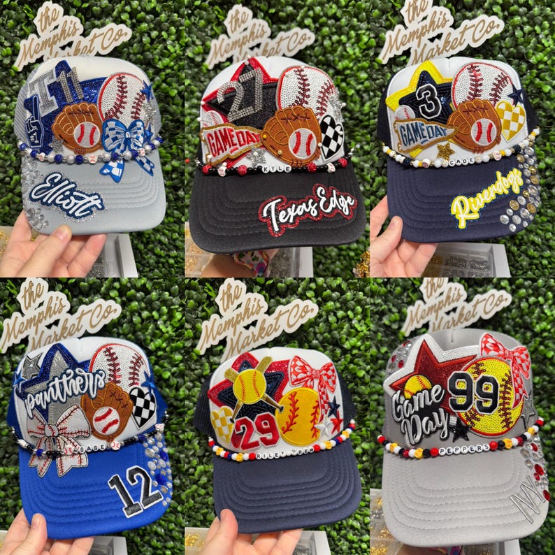 May include: Six baseball-themed trucker caps with different designs. Each cap features baseballs, gloves, and decorative elements. Some caps have text like "Elliott", "Texas Edge", "Game Day", and numbers. The caps are embellished with rhinestones and bows.