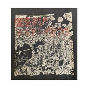 May include: A black t-shirt featuring a white and red graphic print. The design depicts a crowd, a person with a spiked mohawk, and a police officer. The text reads "CRASS" in red and "THEY'VE GOT A LOT OF NERVE" in red, with additional text below.