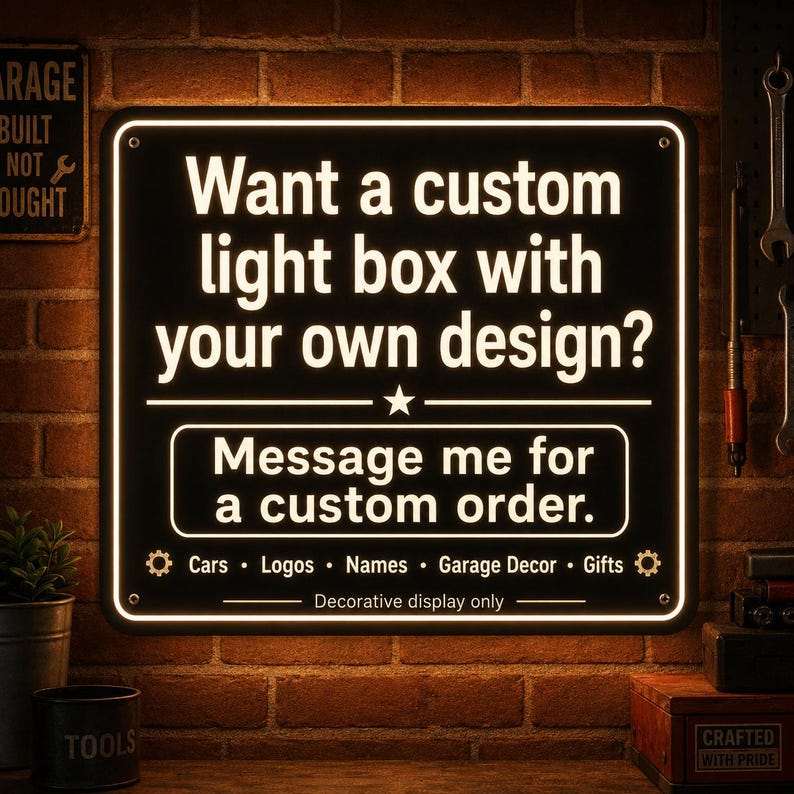 May include: A rectangular black light box sign with white illuminated text that reads: Want a custom light box with your own design? Message me for a custom order. Cars, Logos, Names, Garage Decor, Gifts. Decorative display only.
