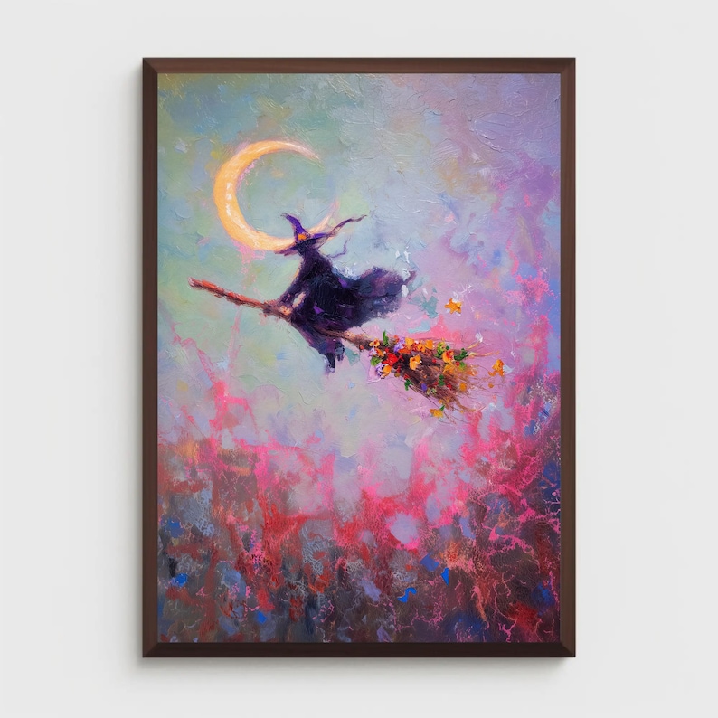 May include: A framed painting depicts a witch on a broomstick flying past a crescent moon. The witch wears a black hat and cloak, and the broom is adorned with flowers. The background features a colorful, abstract blend of pink, blue, and yellow hues.
