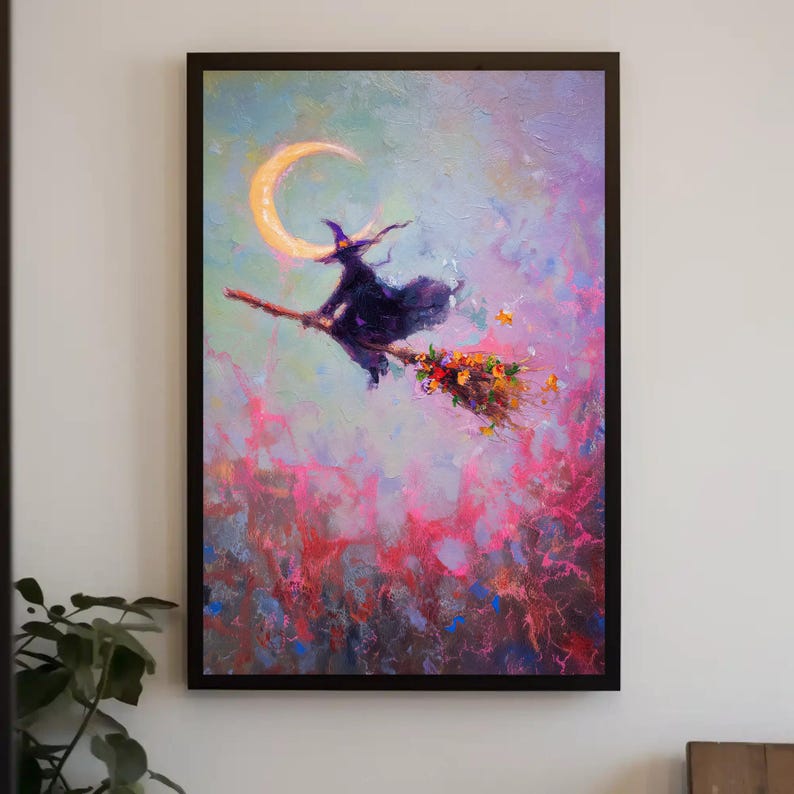 May include: A framed painting depicts a witch on a broomstick flying past a crescent moon. The witch is wearing a black hat and cloak. The broom is decorated with flowers. The background is a mix of pink, purple, and blue.