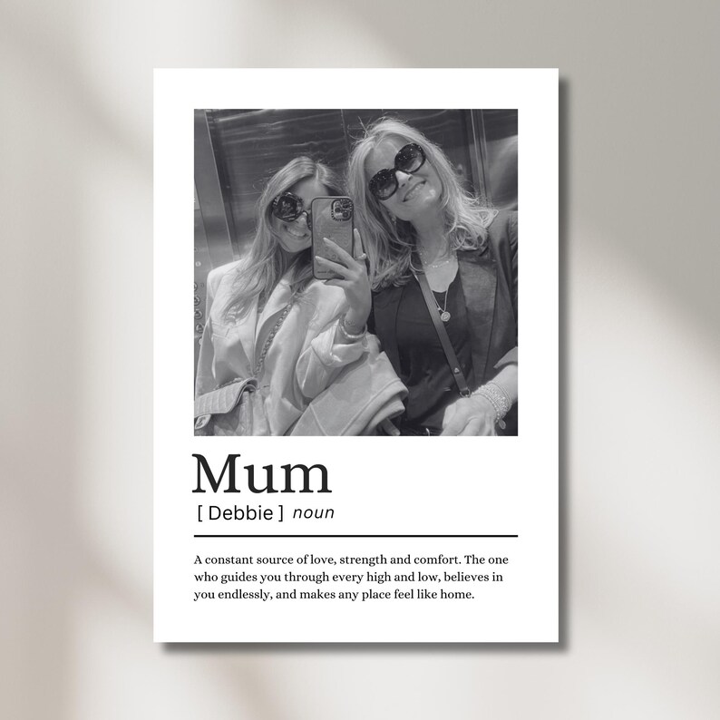 May include: Black and white print featuring a selfie of two women wearing sunglasses. The word "Mum" is printed below the photo, along with a definition. The definition describes a mother as a source of love, strength, and comfort.