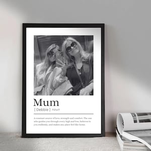 May include: Black and white framed print featuring a photograph of two people taking a selfie. The print includes the word "Mum" with a definition below, describing a constant source of love and strength.