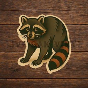 May include: A raccoon sticker with a vintage design. The raccoon is depicted in shades of brown, black, and tan, with a striped tail. The sticker has a cream-colored border and is set against a wooden background.
