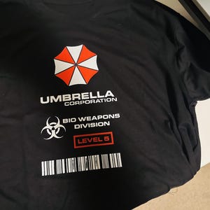 Biohazard Response Division T-Shirt | Retro Sci-Fi Corporate Emblem Tee | Tactical Countermeasure Sleeve Patch Shirt