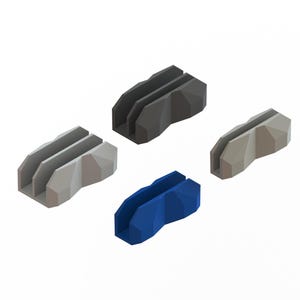 May include: Four geometric desk organisers in shades of grey, dark grey, and blue. Each organiser has a slot for holding items. The design is modern and minimalist.