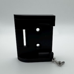 May include: A black plastic wall mount with two holes and a screw slot. A silver screw is included.