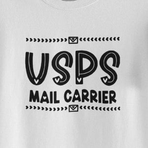 May include: White t-shirt with black text that reads "USPS Mail Carrier" with a stylized graphic of a mailbox and the letters USPS.