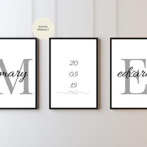 May include: Three framed prints with black borders. The left print says "mary" with a large gray "M". The center print has the numbers "20 05 15" and a decorative line. The right print says "edvard" with a large gray "E".