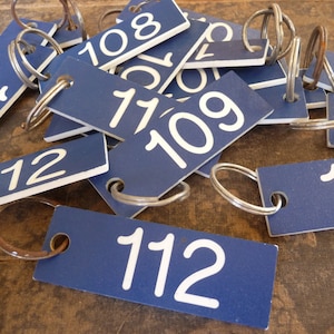 Vintage blue motel key with white number and key ring