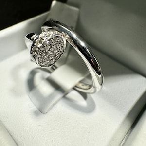 14 k white gold ring “Nail”. Weight 5,97 g. Diamond 0,15 ct. Size: US 7 3/4.