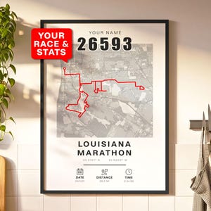 May include: Framed print featuring a map of the Louisiana Marathon route in red, with the text "LOUISIANA MARATHON". Includes race stats: date, distance (26.2 mi), and time. The text "YOUR RACE & STATS" is in a red speech bubble.