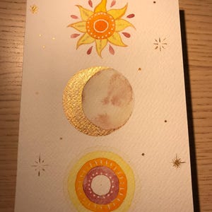 Hand painted watercolor card with the theme of "stars", sun and moon.